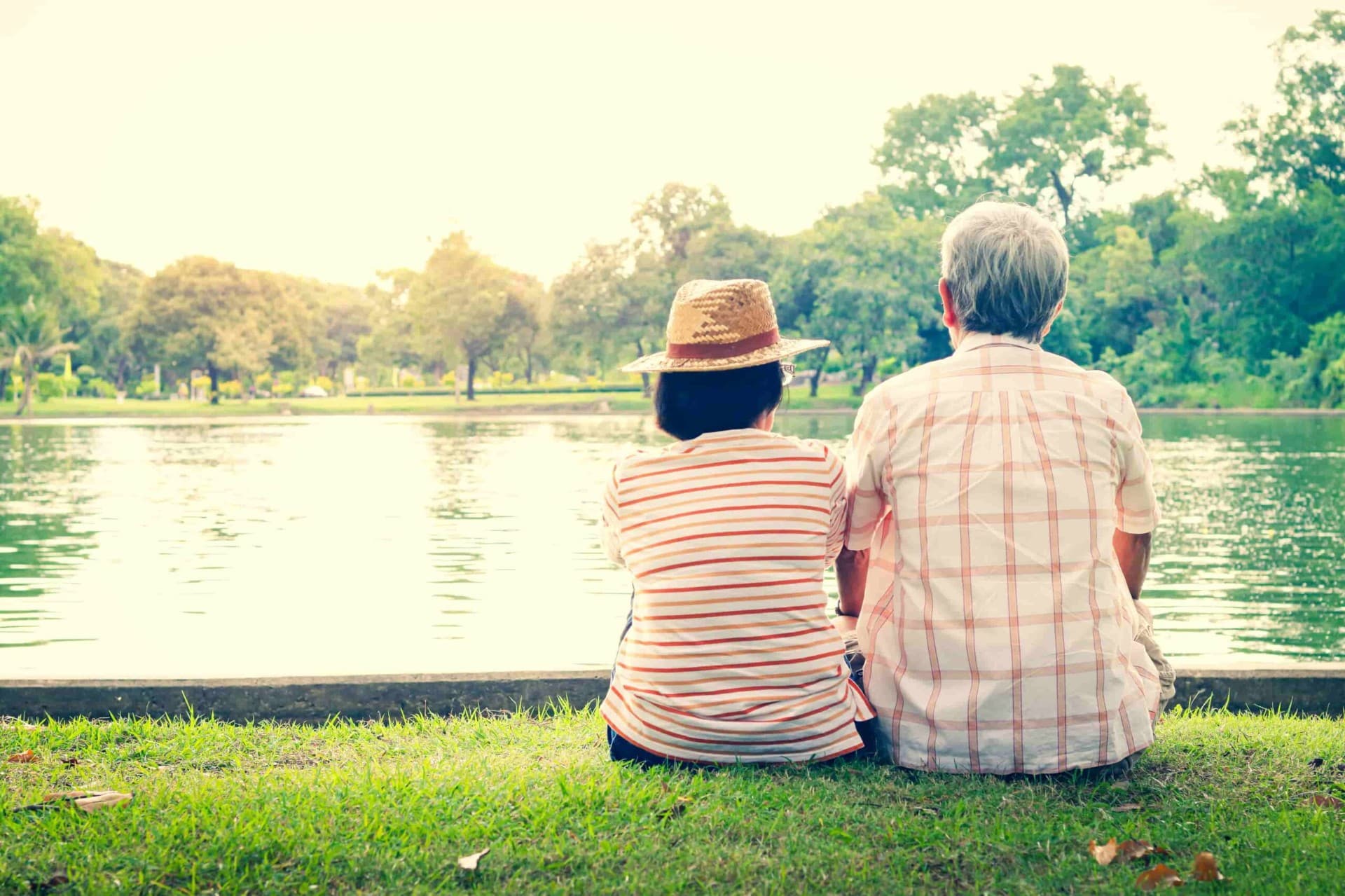 Couple sitting together by a lake, symbolizing emotional connection and support in couples counseling for healthy relationships.